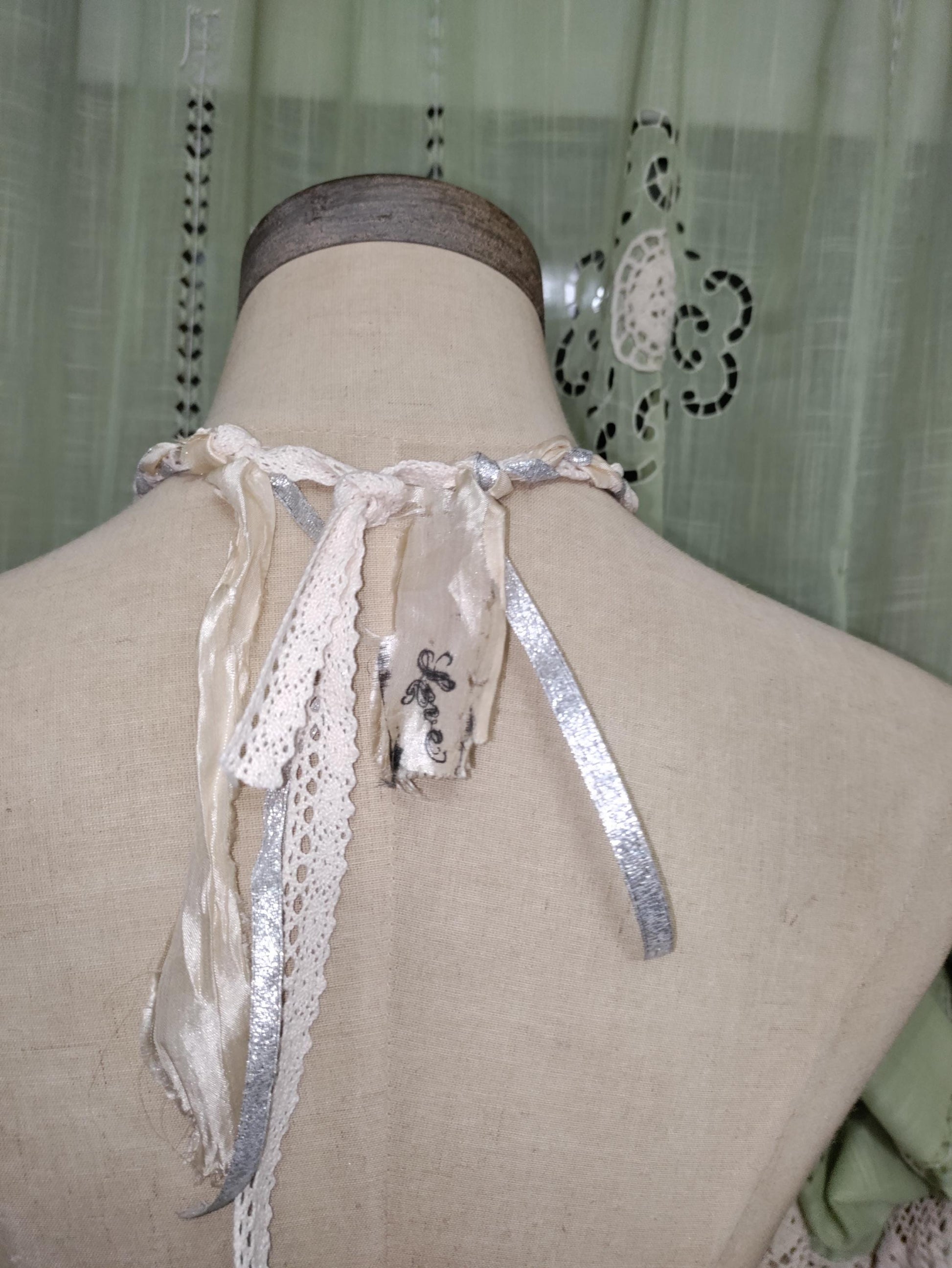 Frozen Charlotte's Wings. Up to Heaven on ribbons of crochet, silk ivory and silver sparkling ribbons. Fidget with a piece of the past!