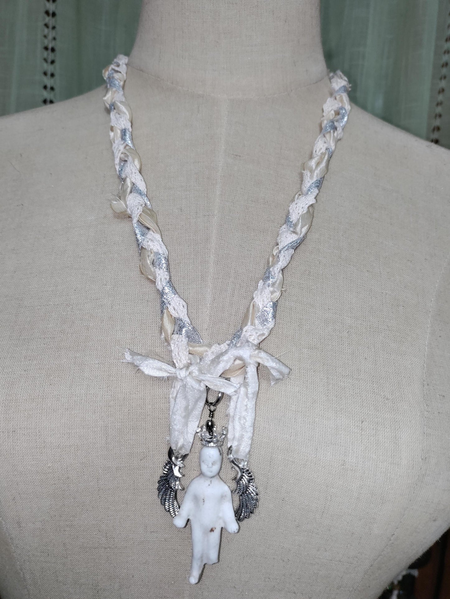 Frozen Charlotte's Wings. Up to Heaven on ribbons of crochet, silk ivory and silver sparkling ribbons. Fidget with a piece of the past!