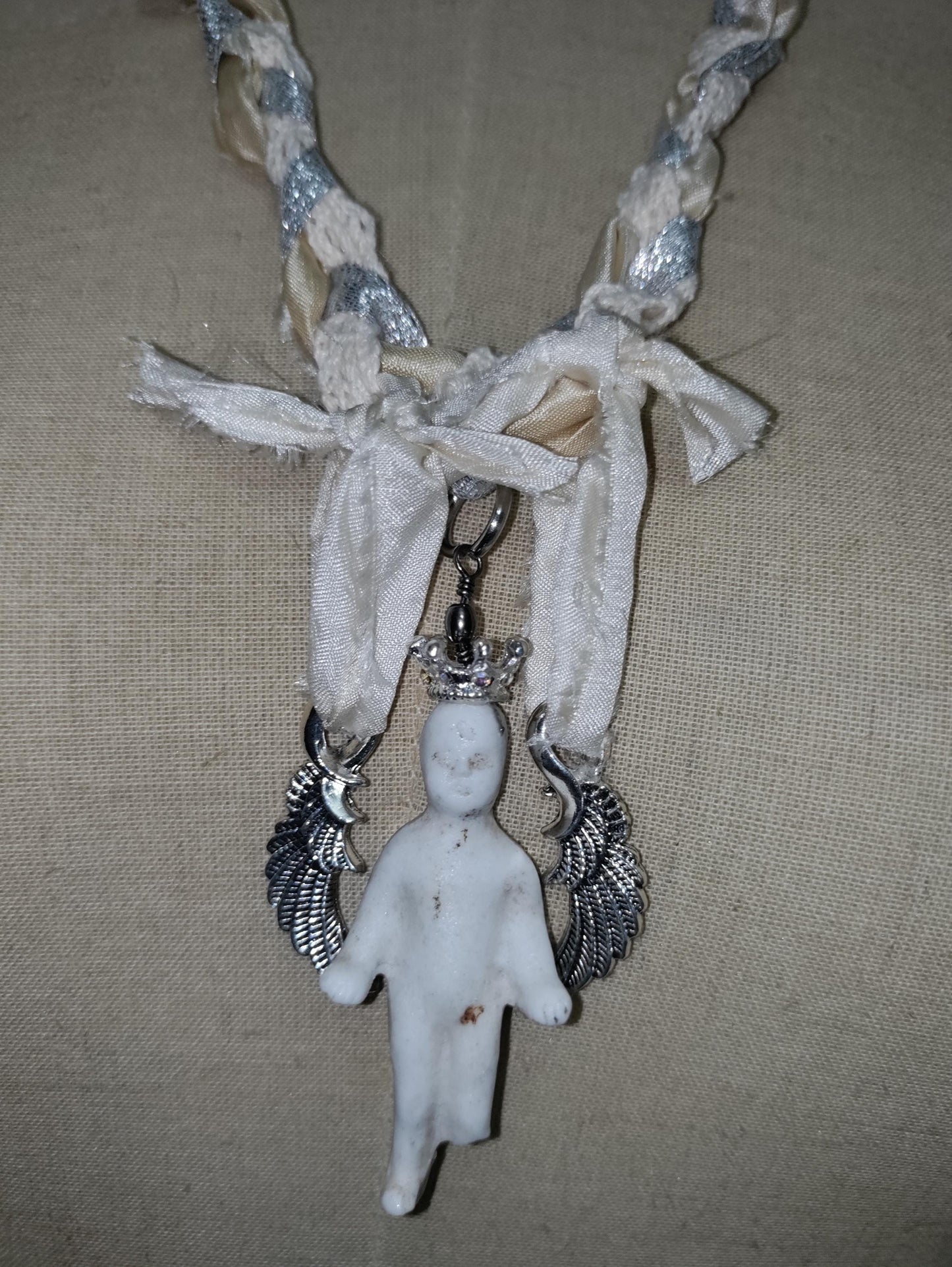 Frozen Charlotte's Wings. Up to Heaven on ribbons of crochet, silk ivory and silver sparkling ribbons. Fidget with a piece of the past!