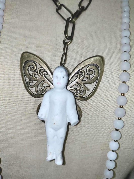 Frozen Charlotte with butterfly wings, with white frosted beads, necklace.