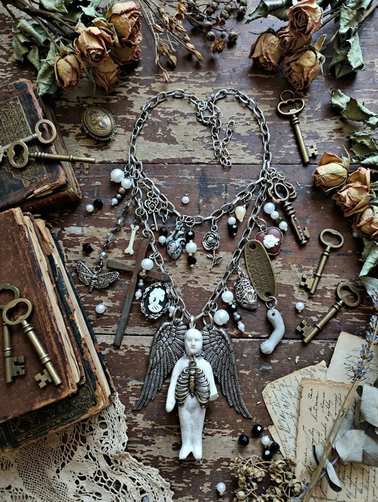 Gothic Angel Necklace: Antique Bisque Doll, Ribcage, Skull, Cross Heart Charms