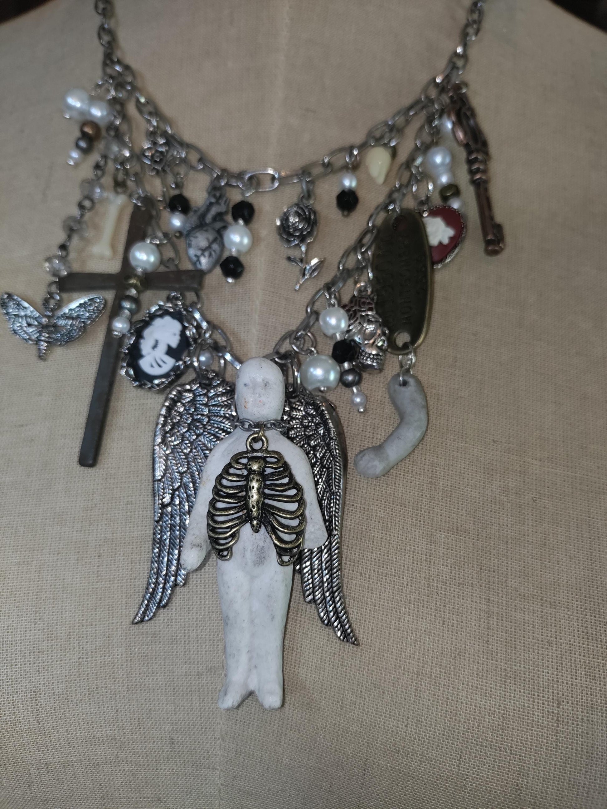 Gothic Angel Necklace: Antique Bisque Doll, Ribcage, Skull, Cross Heart Charms