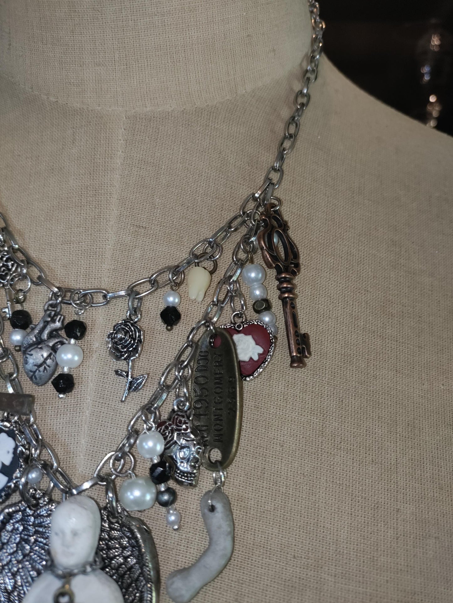 Gothic Angel Necklace: Antique Bisque Doll, Ribcage, Skull, Cross Heart Charms