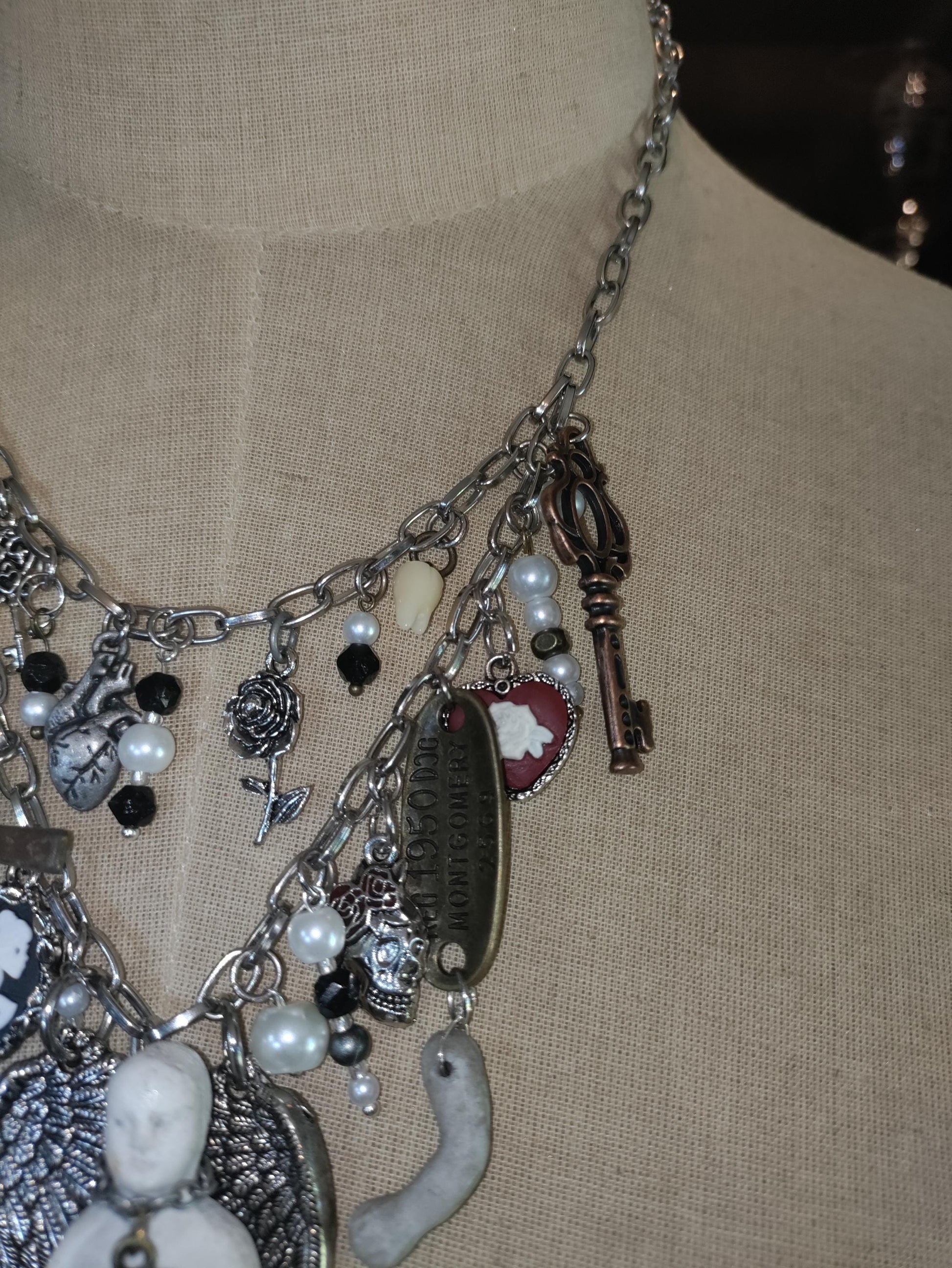 Gothic Angel Necklace: Antique Bisque Doll, Ribcage, Skull, Cross Heart Charms