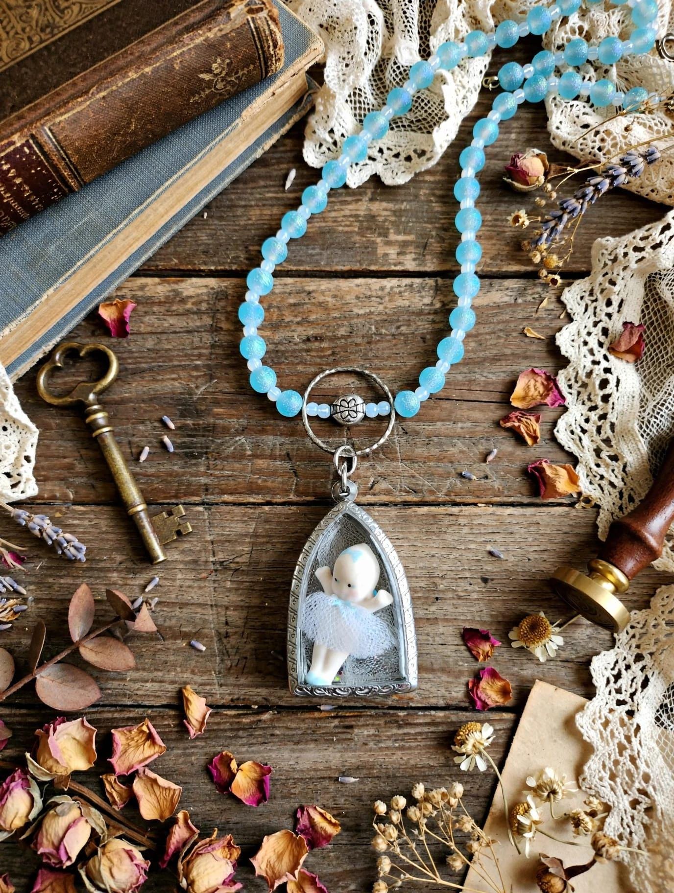 Tiny Dancer Kaptured Kewpie Doll: Frosted Blue Glass Beads. White Opalescent Beads.