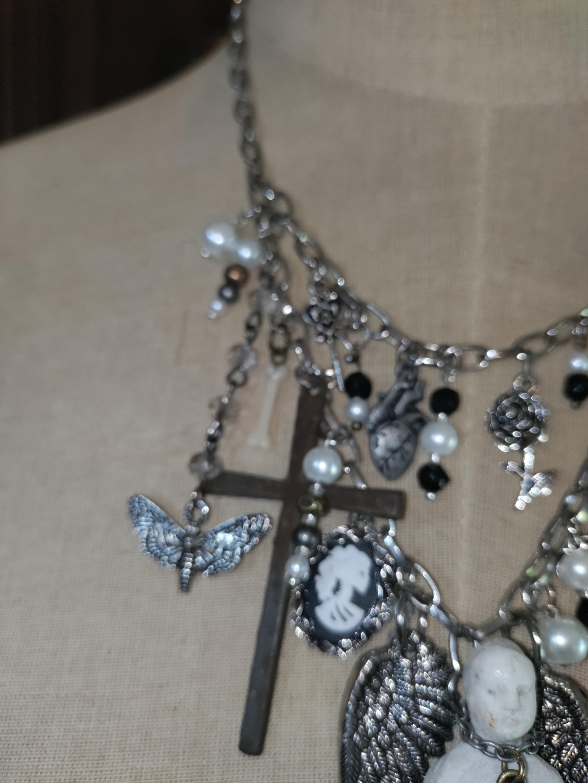 Gothic Angel Necklace: Antique Bisque Doll, Ribcage, Skull, Cross Heart Charms