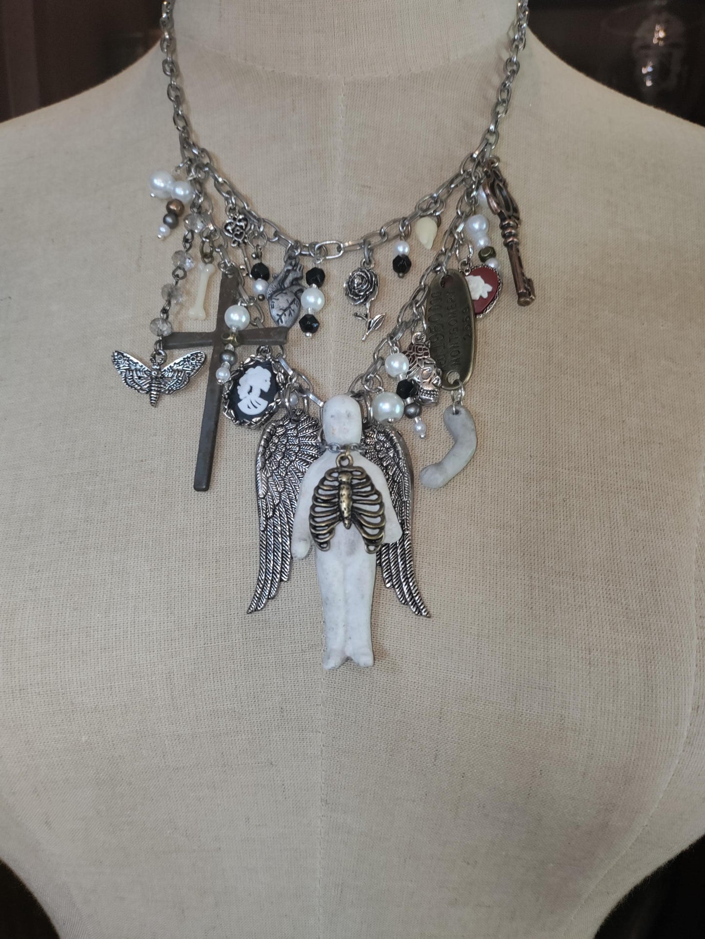 Gothic Angel Necklace: Antique Bisque Doll, Ribcage, Skull, Cross Heart Charms