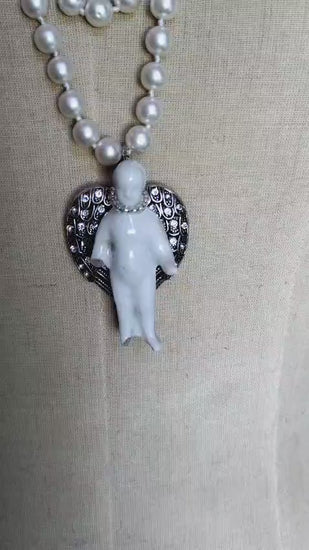 Video of the Ascending Frozen Charlotte necklace showing the knotted pearl strand and silver angel wing pendant from multiple angles