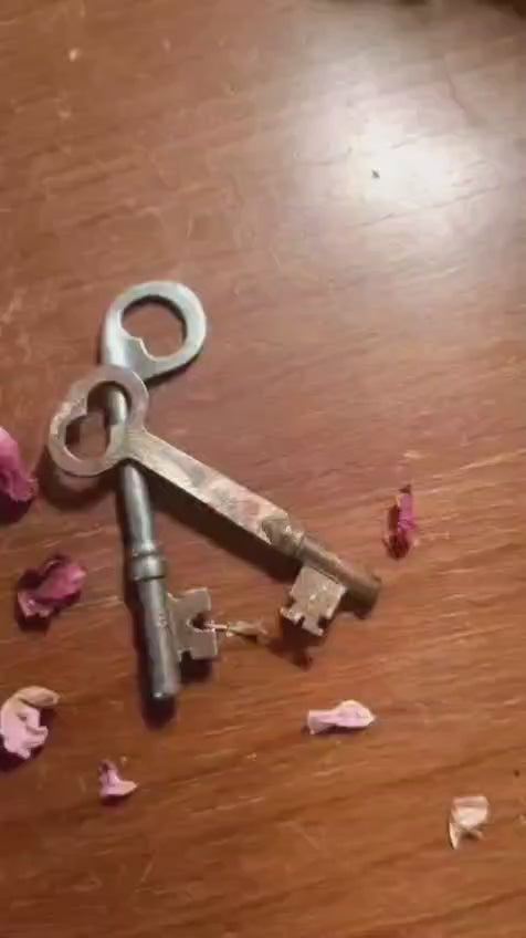 Video of the Skeleton Key necklace showing the bisque doll pendant with brass skeleton key and crystal drop in motion